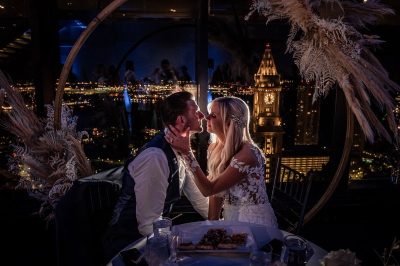 Intimate sweetheart table moment with night city view