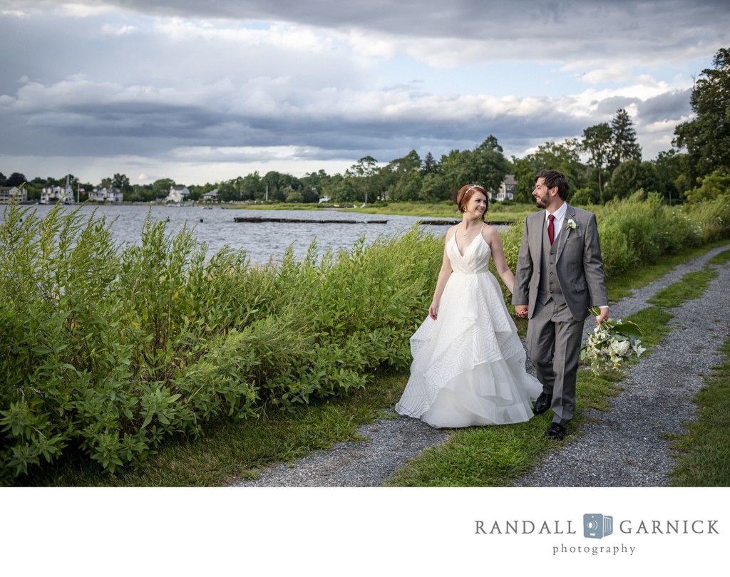 Bride and groom walking by water Blithewold Mansion wedding