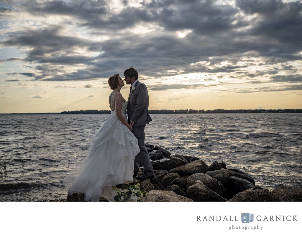 Bride and groom on rocks Blithewold Mansion wedding waterfront