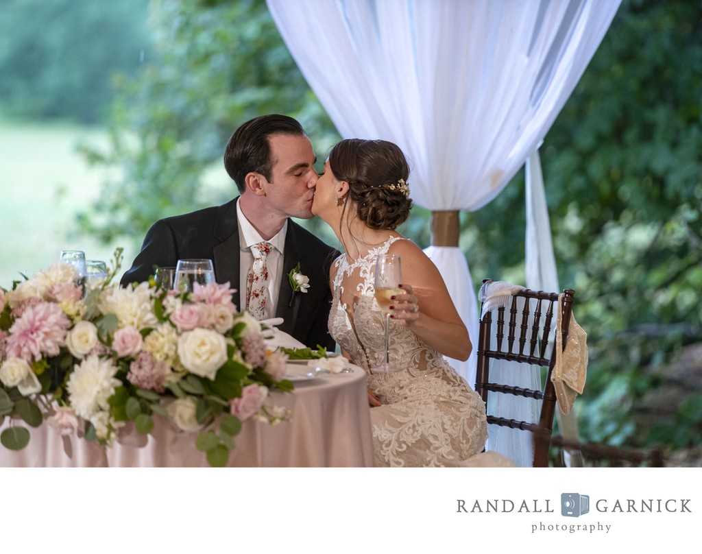 Bride and groom kiss Blithewold Mansion wedding reception