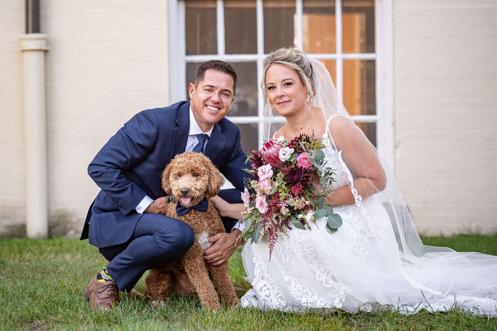 Classic wedding portrait with their dog outside the 1620 Winery in Plymouth.