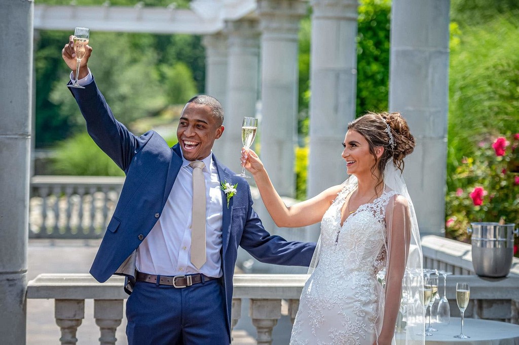 Happy wedding couple raise a toast after their ceremony at Grand View in Mendon.