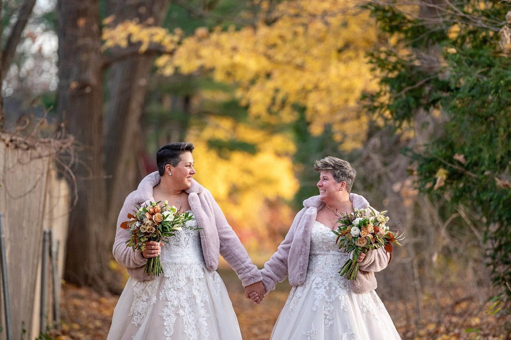 Two brides with the Fall foliage at The Inn at Hastings Park.