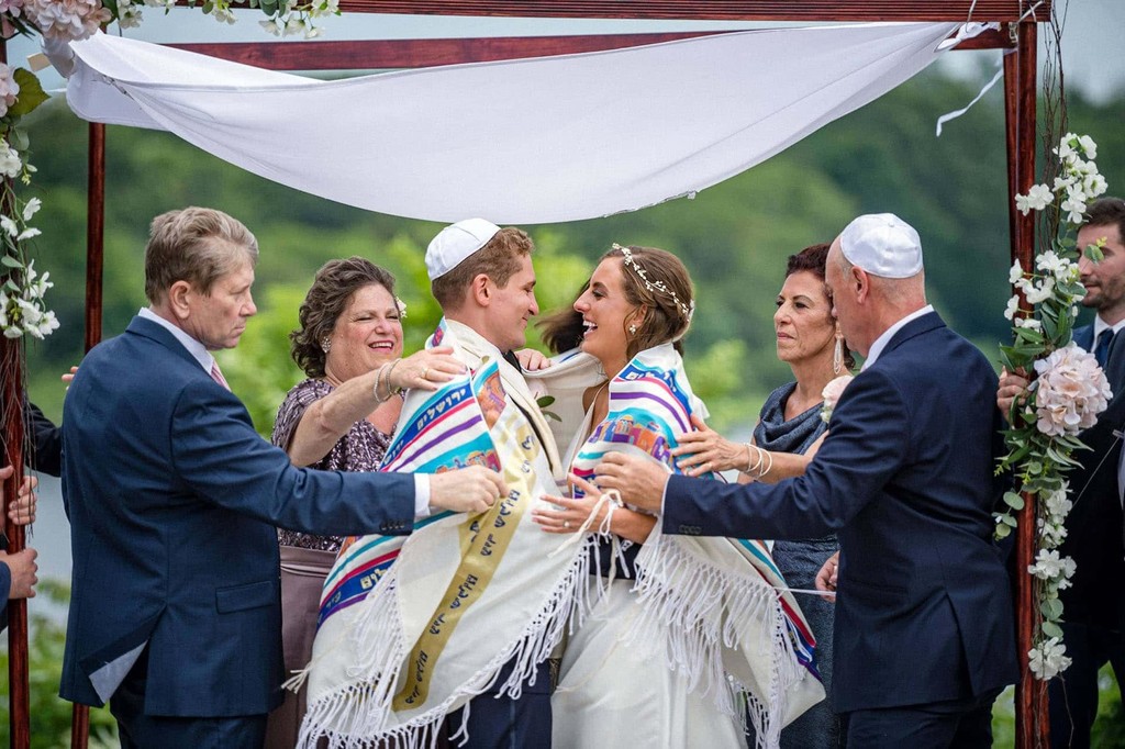 Jewish couple laughing during their ceremony at the Plimoth Patuxet Museum.