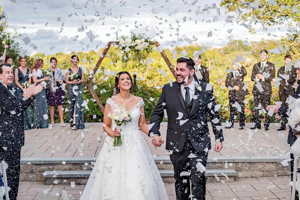 Happy couple surrounded by confetti at the Plimoth Patuxet Museum.