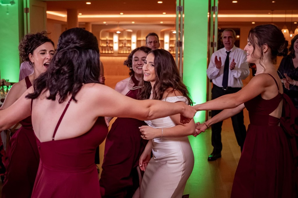 bride-dancing-with-bridesmaids-lakehouse-wedding