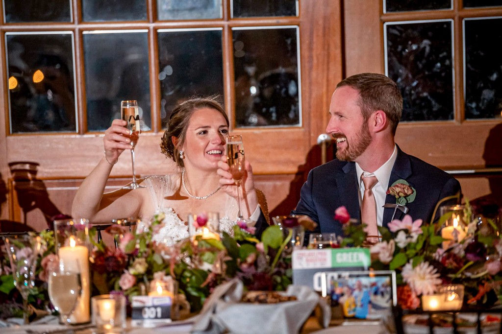 Newlyweds toasting during Elm Bank wedding dinner