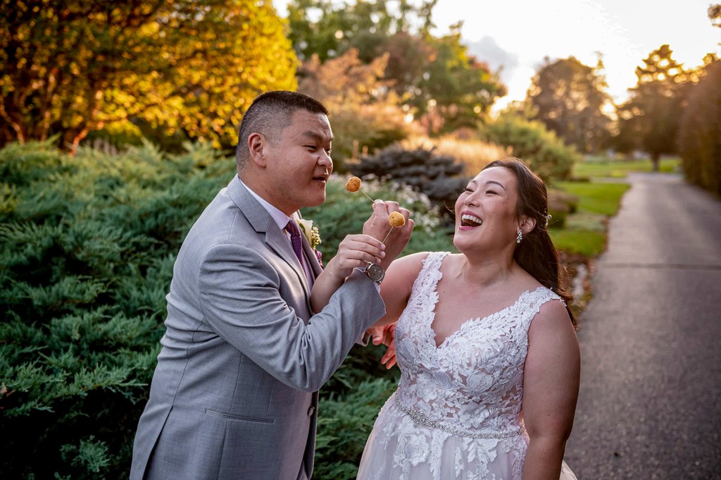 Groom and bride laughing at Elm Bank wedding