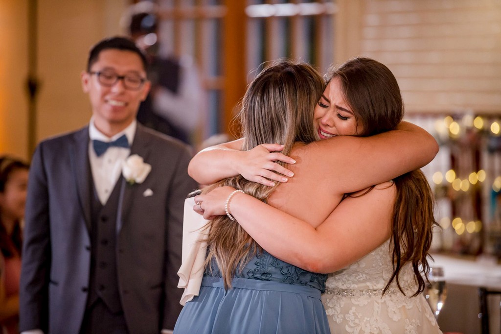Bride hugging maid of honor at Elm Bank wedding