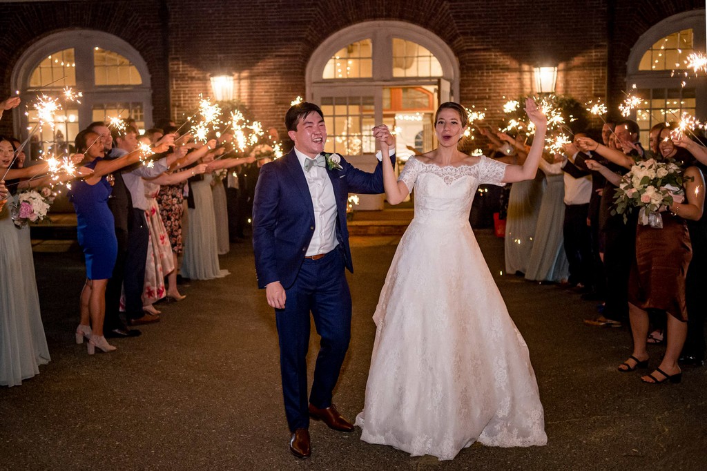 Bride and groom celebrating with sparklers at Elm Bank wedding reception