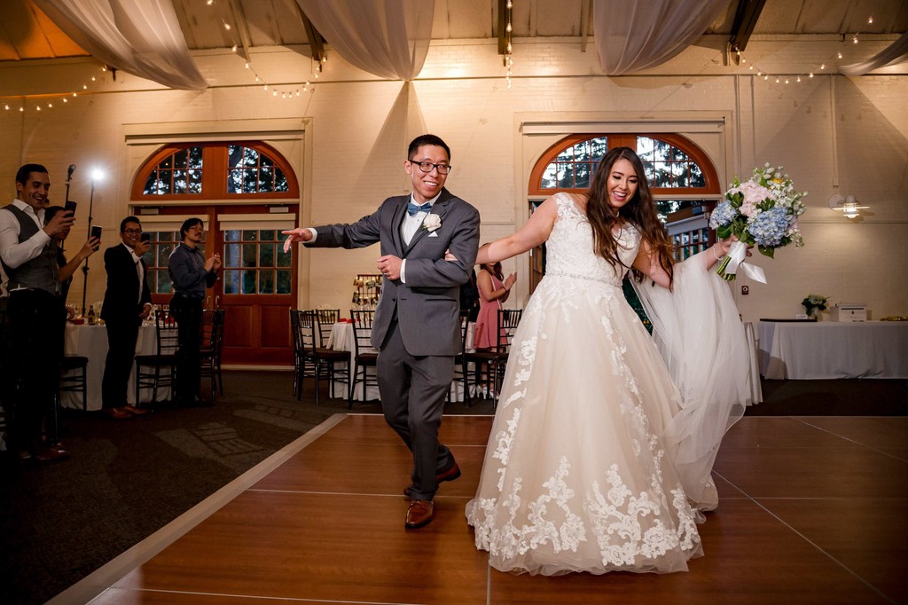 Bride and groom entering wedding reception at Elm Bank venue