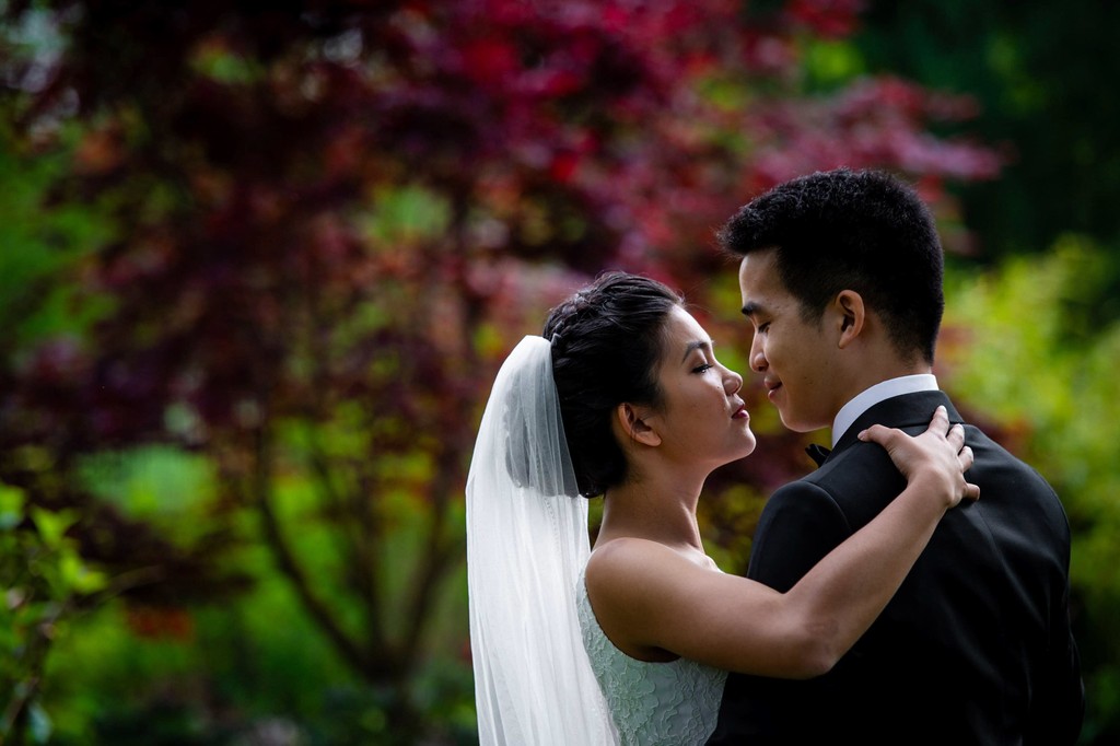 Newlyweds sharing an intimate moment in the gardens at Elm Bank wedding