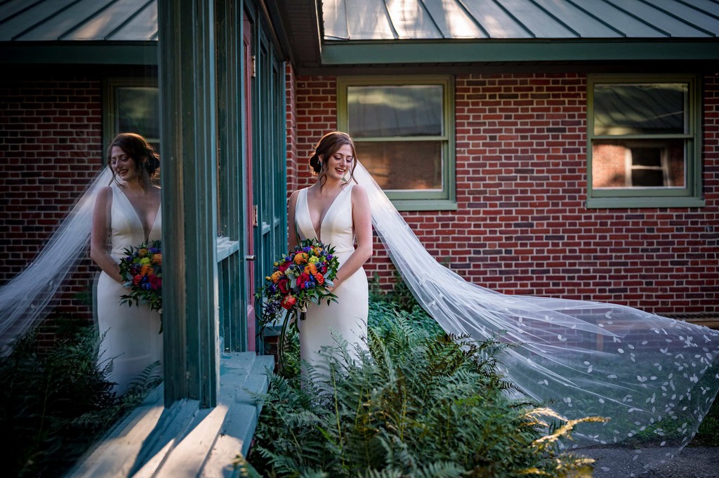 Bride and flowing veil outside Elm Bank wedding venue