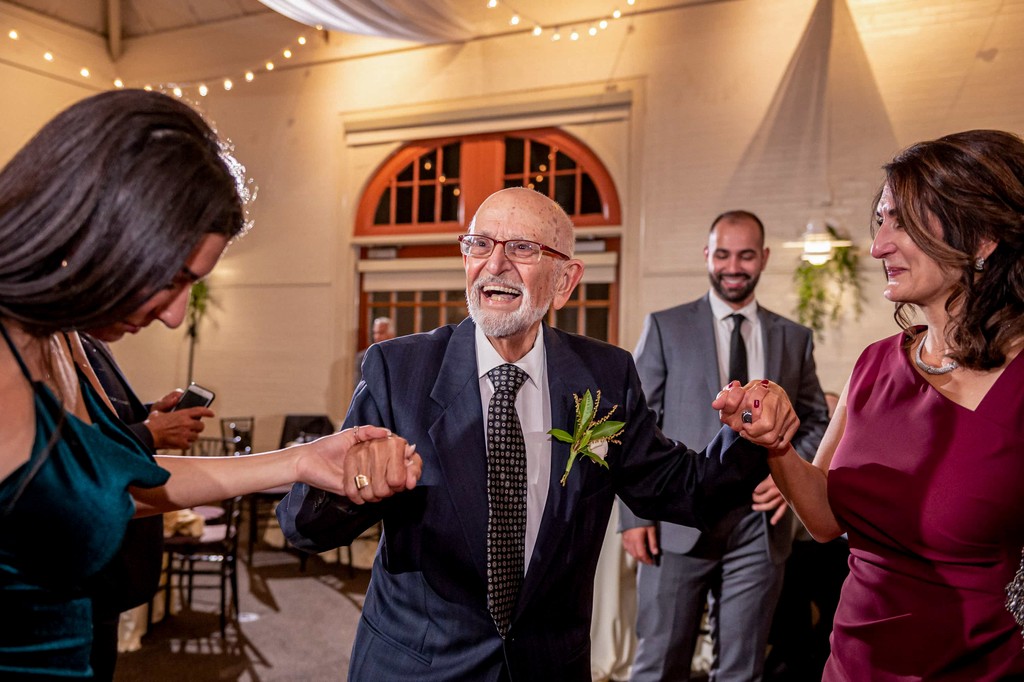 Grandfather shows off his dance skills at an Elm Bank wedding