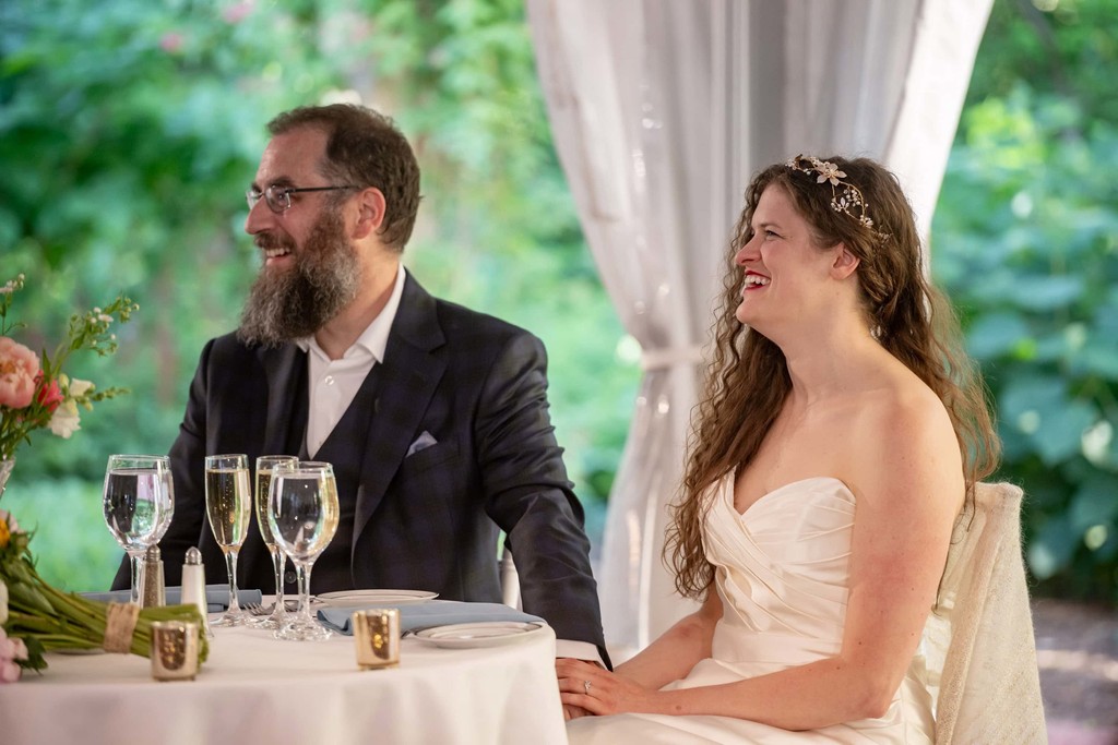 Couple laughing during speeches at Long Hill Beverly wedding