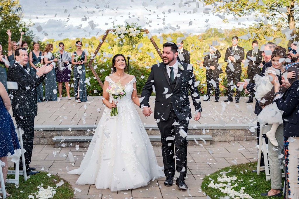 Just married confetti exit after an outdoor wedding ceremony
