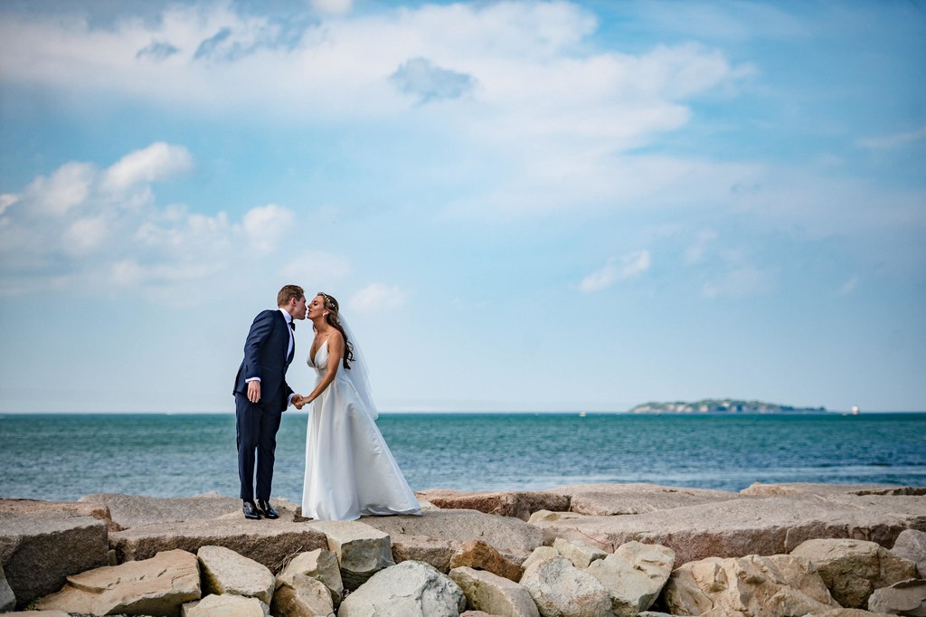 Rocky pier kiss moment on the ocean with beautiful clouds