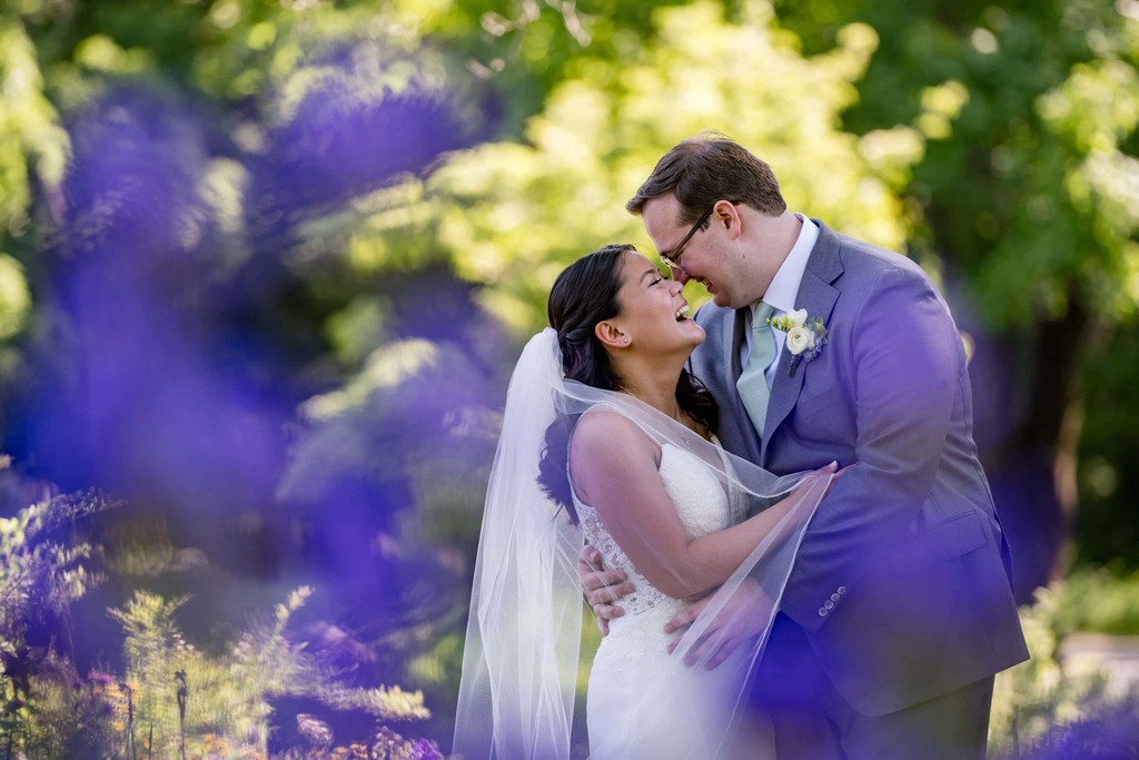 Spring garden portrait with bride and groom laughing