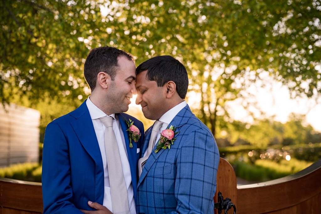 Same-sex couple soft embrace during sunset