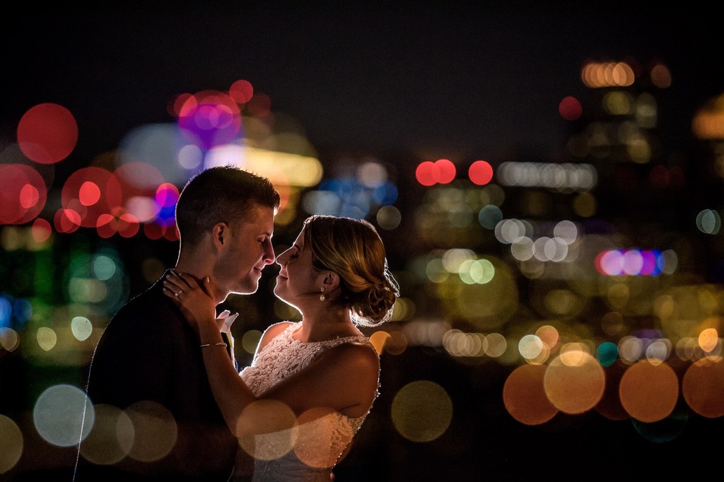 Bride and groom romantic night photo with Boston city lights in the background
