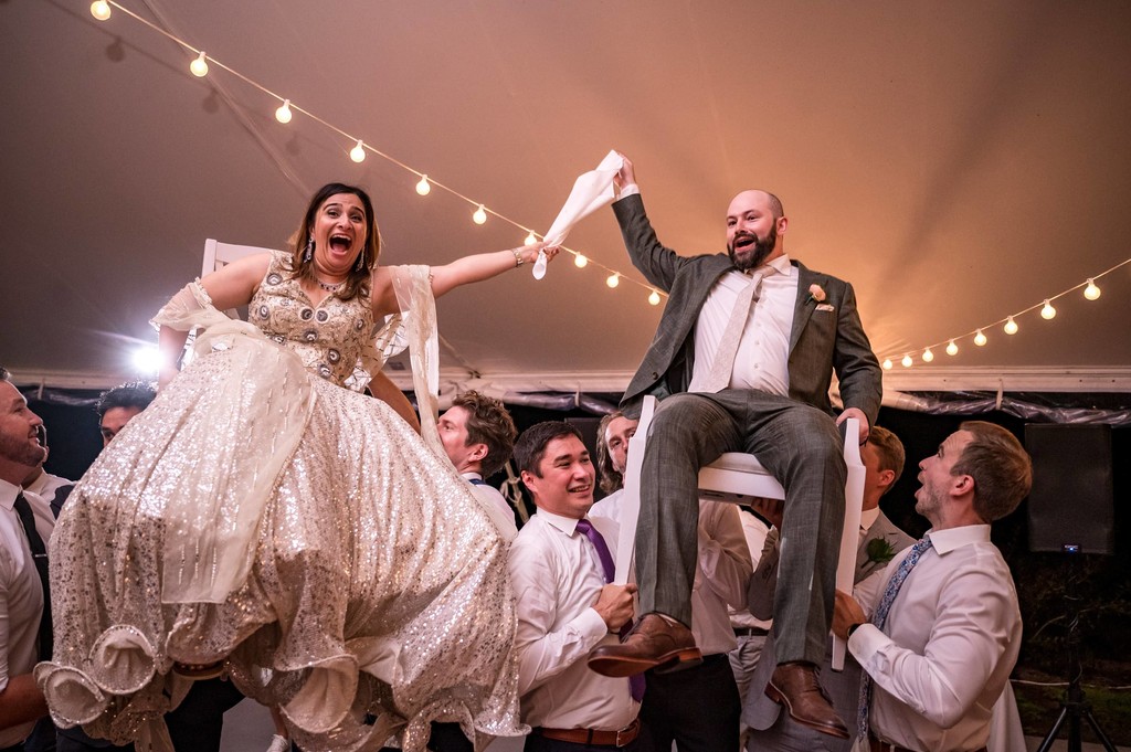 Hora dance celebration in a tent with twinkle lights
