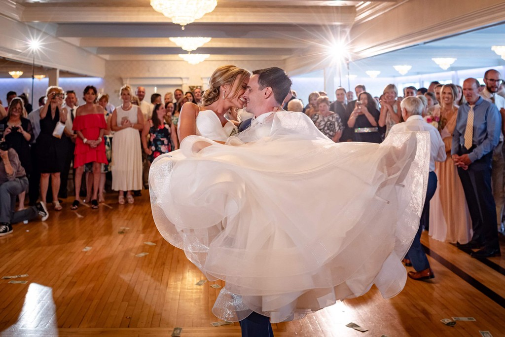 First dance lift and kiss at a modern wedding venue
