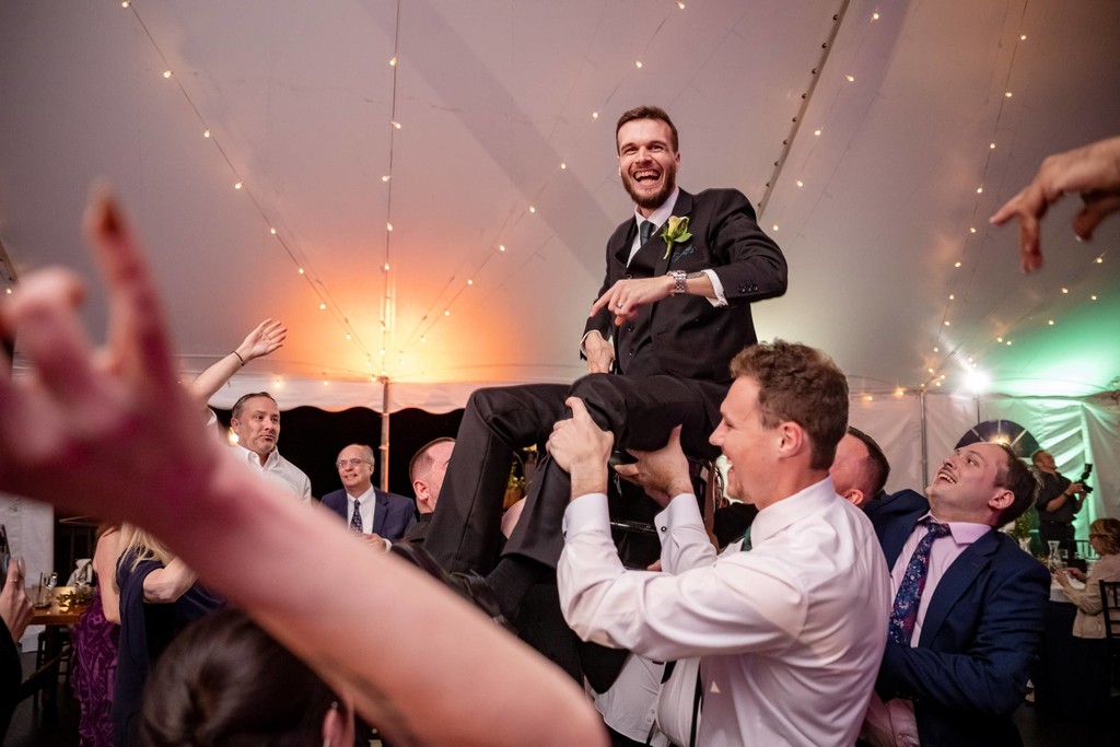 Groom carried during the dancing at Fern Hill Barn reception