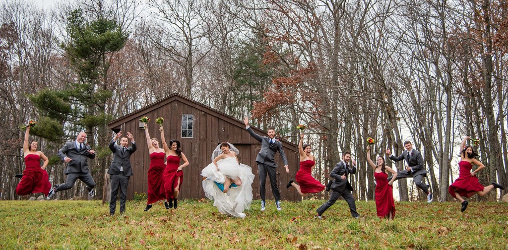 Wedding party in red outside Fern Hill Barn in winter