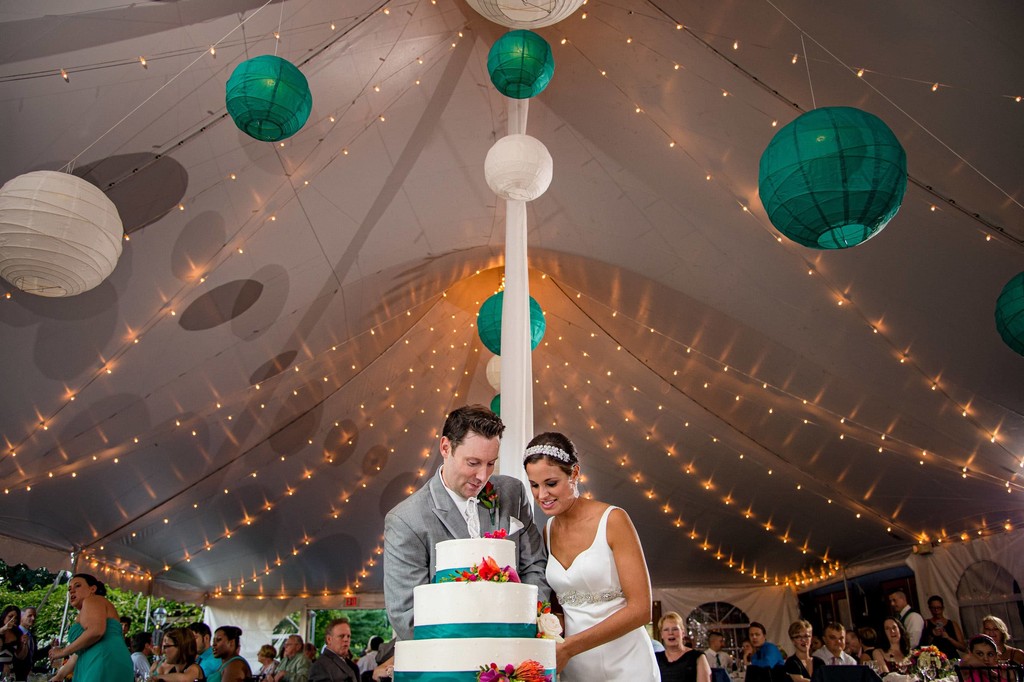 Cake cutting under lanterns – Fern Hill Barn reception