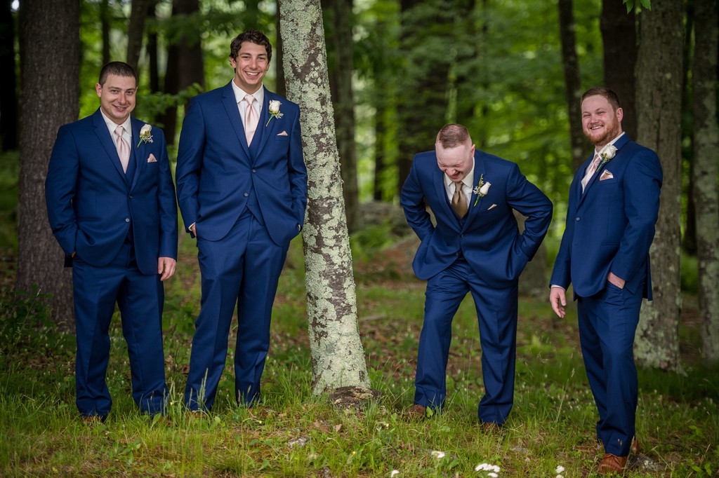 Groom and groomsmen laughing at Fern Hill Barn