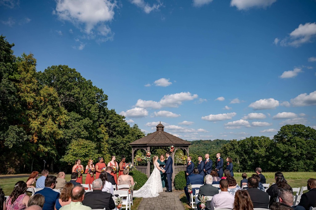 Outdoor ceremony scene at Fern Hill Barn with mountain backdrop