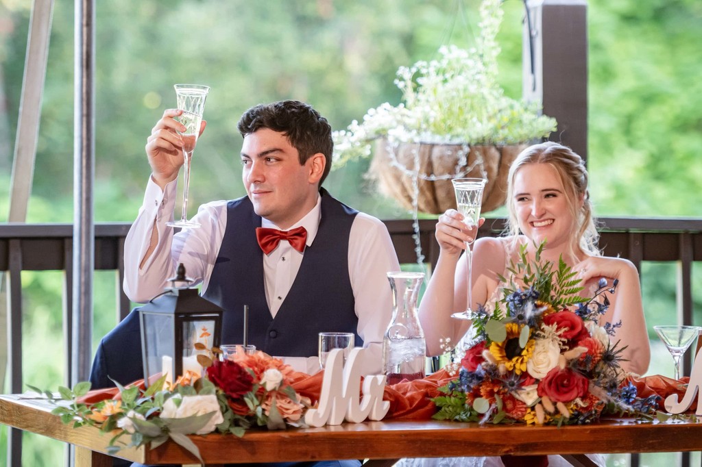 Elegant head table dinner toast at Fern Hill Barn