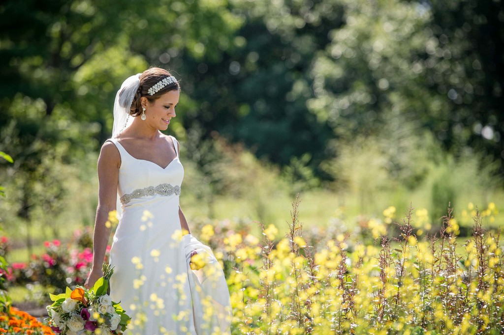 Bride walking through wildflowers at Fern Hill Barn