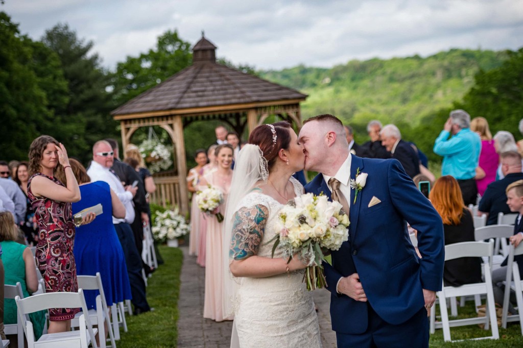 Ceremony recessional kiss at Fern Hill Barn