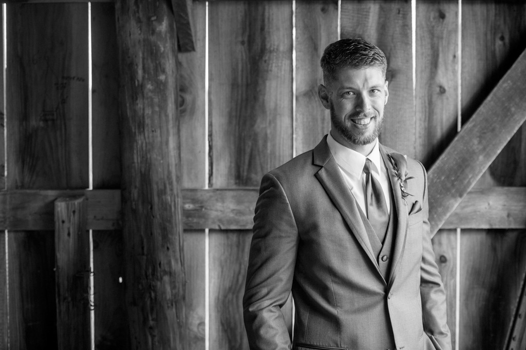 Moody black and white groom portrait at Fern Hill Barn