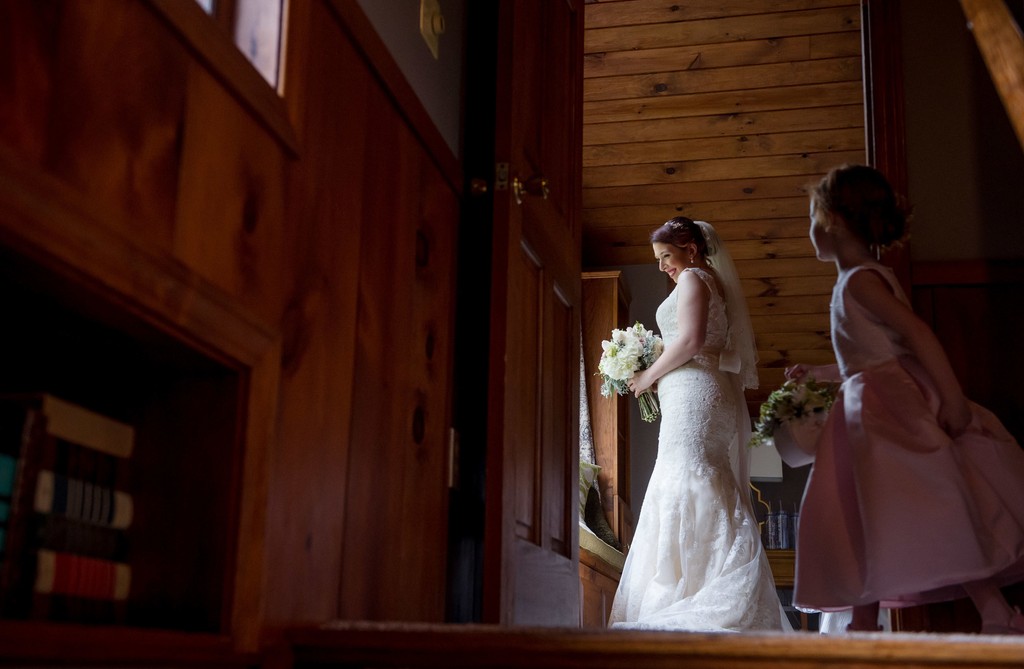Flower girl watches bride prep at Fern Hill Barn wedding