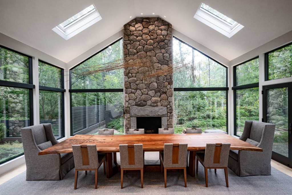 Vaulted ceiling dining room with stone fireplace