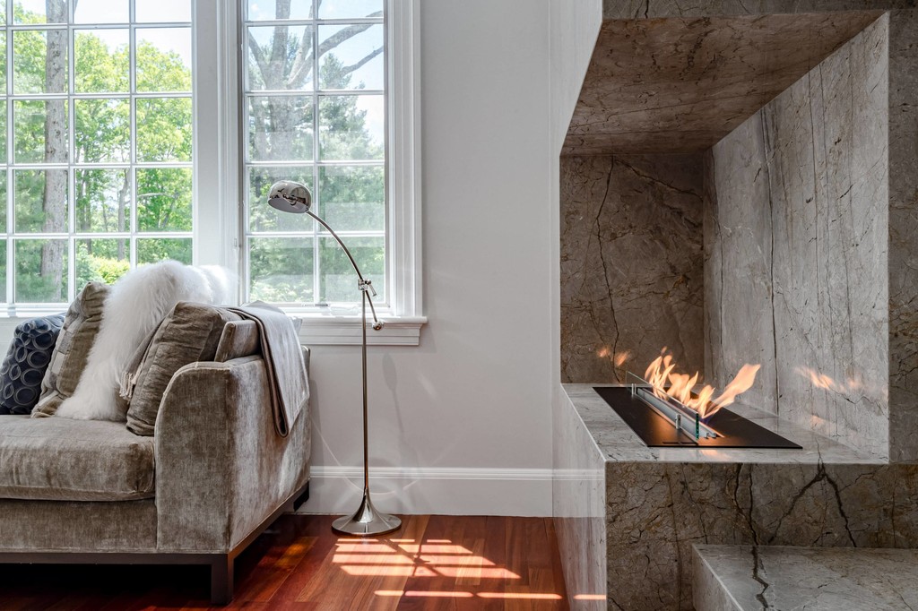 Modern fireplace with concrete surround and soft seating
