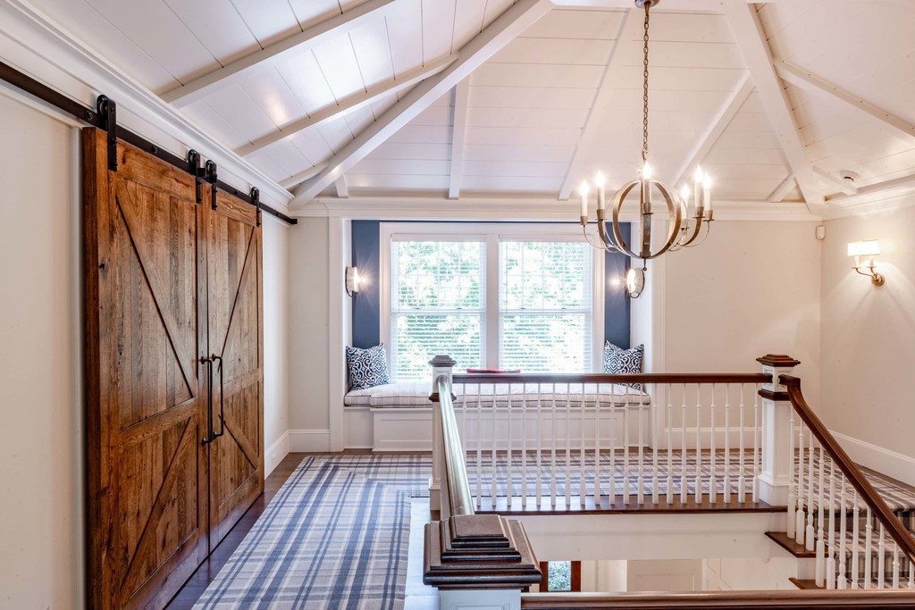Upstairs landing with barn door and cathedral ceiling