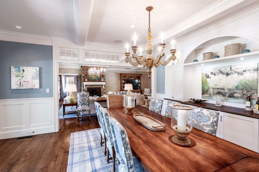 Formal dining room with chandelier and wall paneling