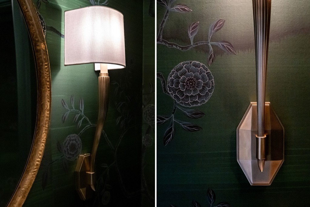 Close-up detail of wall sconce and floral wallpaper design