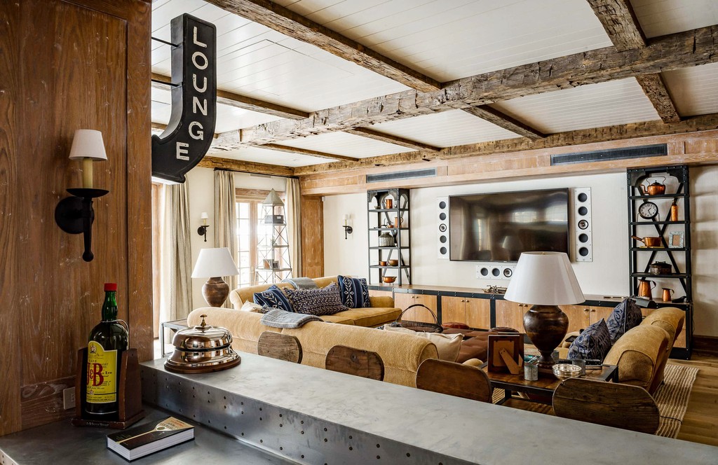 Rustic basement living room with wood beams and eclectic decor