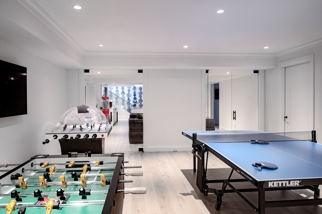 Home game room with ping pong and foosball tables
