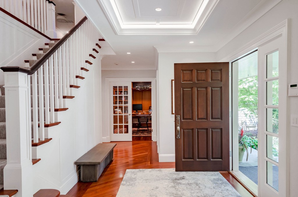 Front entry with wide staircase and wood front door