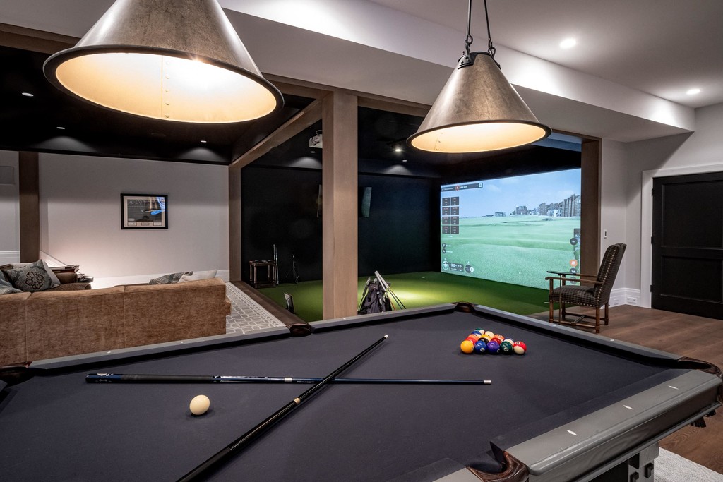 Modern billiards room with pendant lighting and virtual golf
