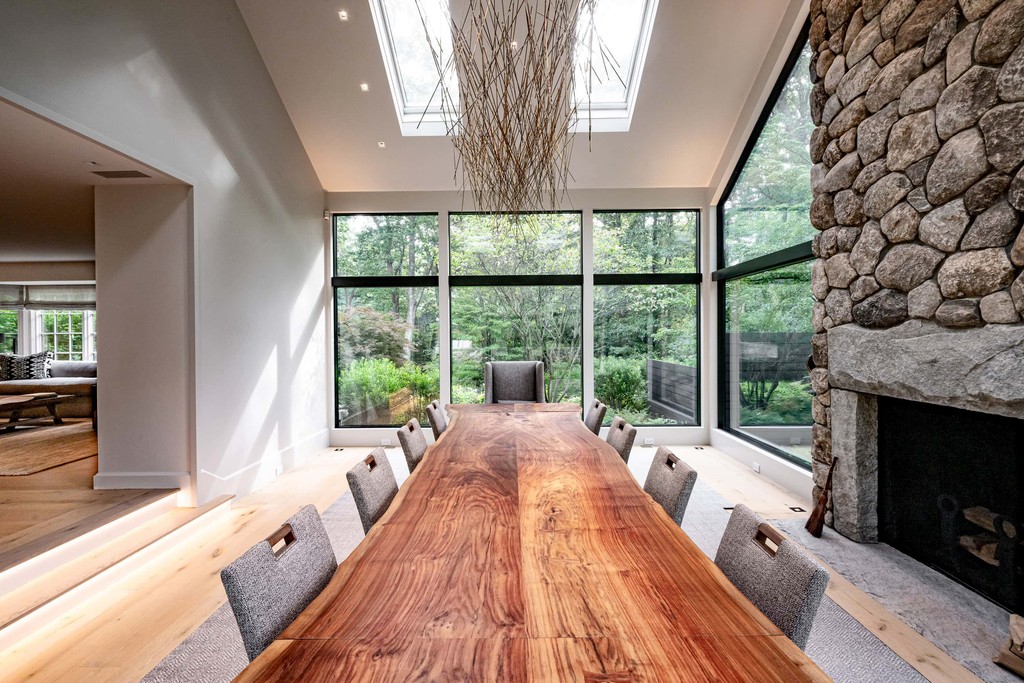 Custom dining table in living space with stone fireplace