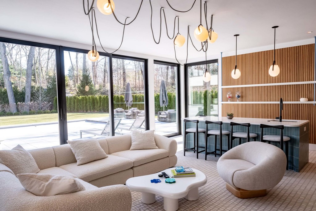 Contemporary pool house with round chairs and floor-to-ceiling windows