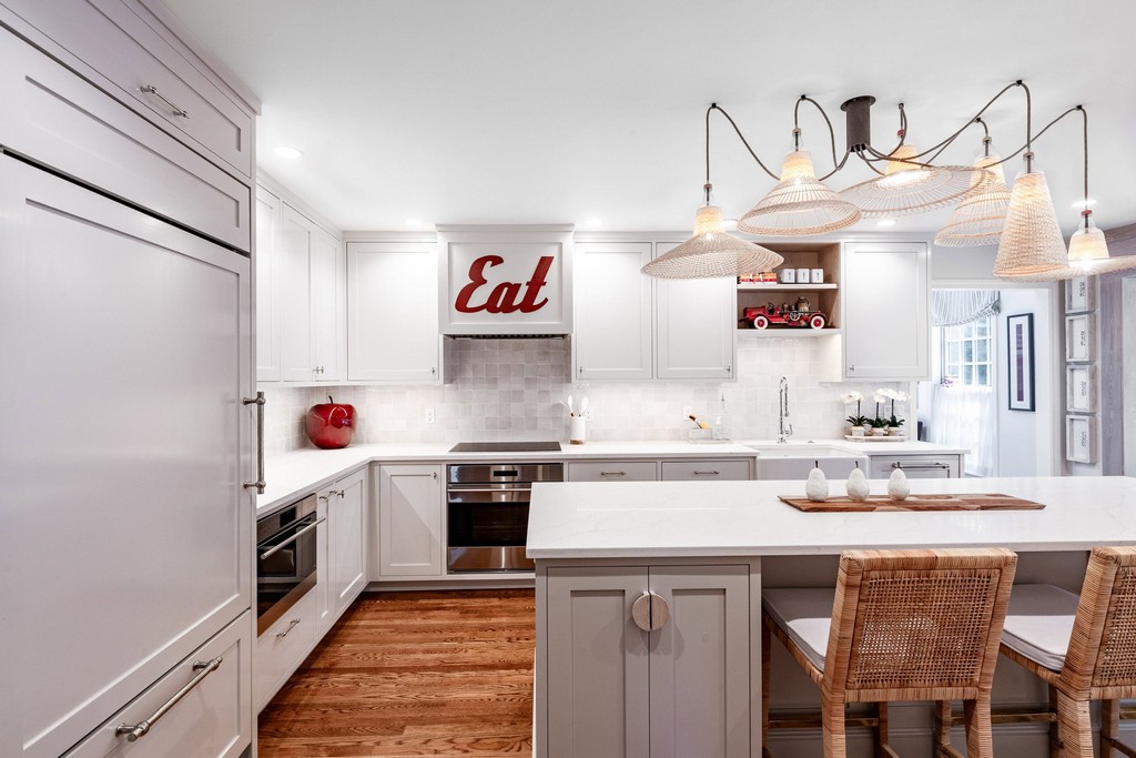 White kitchen with wood accents and pendant lighting