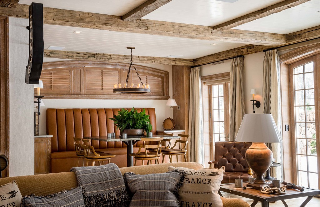 Warm basement lounge with wood details and custom furniture