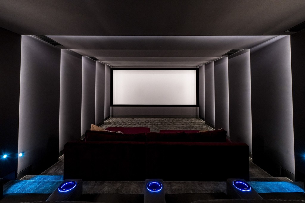 Home theater room with ambient lighting and recliners